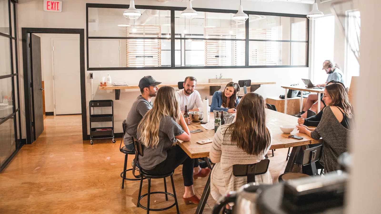 A small team talking around a table in their office