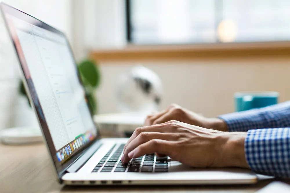 Consultant typing on a laptop