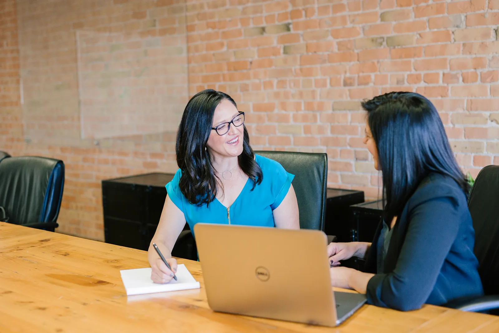 Two colleagues planning at a laptop