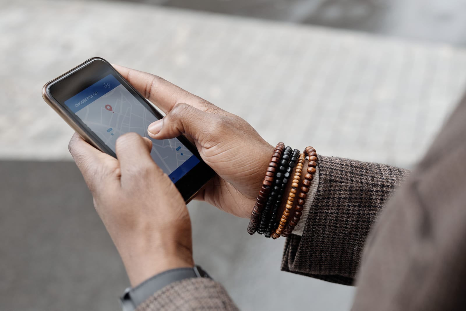 Smartphone held in hand showing a map with a business location pin