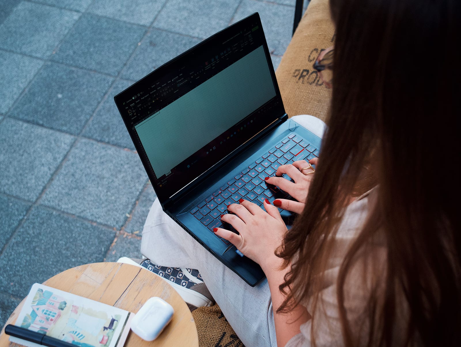 Woman typing a reply on a laptop at a small office desk